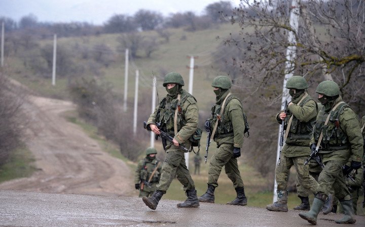Russian soldiers patrol the area surrounding the Ukrainian military unit in Perevalnoye, outside Simferopol, Crimea, Ukraine, on March 20, 2014. Photo by Filippo Monteforte via Getty Images.