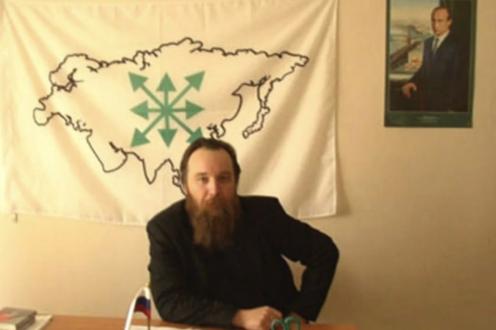 Alexander Dugin with a photo of Vladimir Putin and a map of all the territories he believes Russia should absorb, including Ukraine, Japan and India. Alexander Dugin with a photo of Vladimir Putin and a map of all the territories he believes Russia should absorb, including Ukraine, Japan and India.