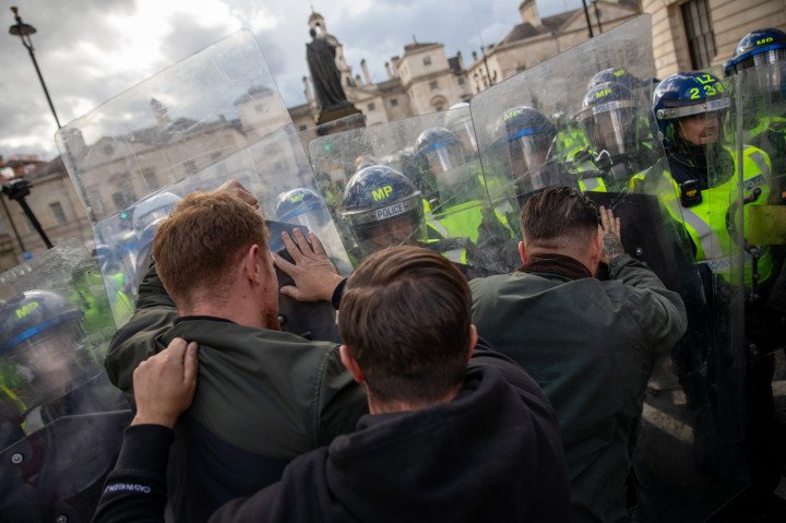 Police riot officers clash with protestors at an anti-immigration demonstration in the UK. (Photo by James Willoughby/SOPA Images/LightRocket via Getty Images)