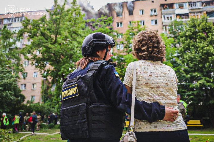 A crisis psychologist comforts a resident near the site of a damaged apartment block in Kharkiv. (Source: State Emergency Service of Ukraine) A crisis psychologist comforts a resident near the site of a damaged apartment block in Kharkiv. (Source: State Emergency Service of Ukraine)