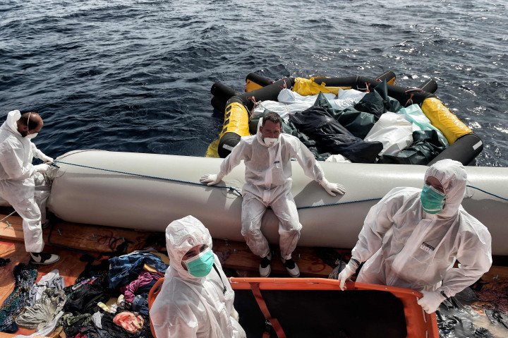 Members of the Spanish NGO Proactiva Open Arms move to a life boat the bodies of 29 refugees and migrants, who died on a rubber boat north of Libya while crossing the Mediterranean Sea (Source: Aris Messinis via Getty Images) Members of the Spanish NGO Proactiva Open Arms move to a life boat the bodies of 29 refugees and migrants, who died on a rubber boat north of Libya while crossing the Mediterranean Sea (Source: Aris Messinis via Getty Images)