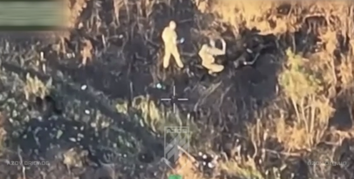 Drone Footage Reveals Russian Soldiers Mutilating Dead Body. (Source: screenshot, Azov Brigade / Telegram) Drone Footage Reveals Russian Soldiers Mutilating Dead Body. (Source: screenshot, Azov Brigade / Telegram)