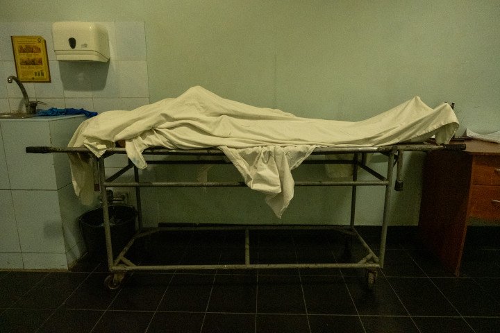 A body inside the morgue is covered with a white sheet. (Photo: Daniel Kosoy / UNITED24 Media)  