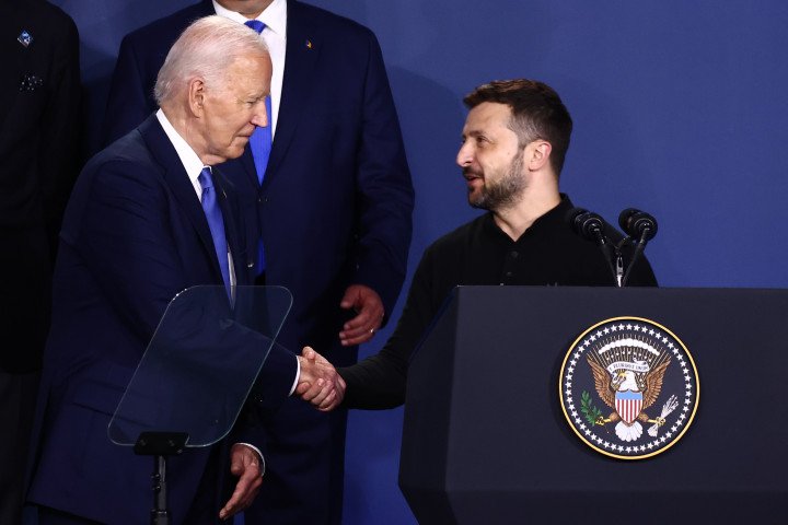 US President Joe Biden and Ukraine President Volodymyr Zelenskyy shake hands at the Ukraine Compact meeting during the 75th NATO Summit. (Source: Getty Images) US President Joe Biden and Ukraine President Volodymyr Zelenskyy shake hands at the Ukraine Compact meeting during the 75th NATO Summit. (Source: Getty Images)