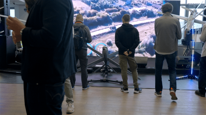 Guests watch a video of “use cases” for loitering drones in the expo hall (Photo: UNITED24 Media)