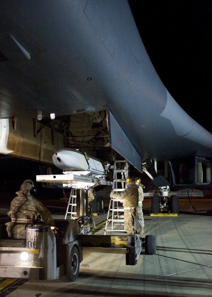 Ground crew loads a cruise missile into the bomb bay of a B-1B Lancer during nighttime operations. (US Air Force photo) Ground crew loads a cruise missile into the bomb bay of a B-1B Lancer during nighttime operations. (US Air Force photo)