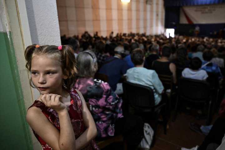 A girl looks on as members of the congregation attend a Sunday service at a Christian Protestant Church in Kramatorsk, 2022. Photo by ARIS MESSINIS/AFP via Getty Images A girl looks on as members of the congregation attend a Sunday service at a Christian Protestant Church in Kramatorsk, 2022. Photo by ARIS MESSINIS/AFP via Getty Images