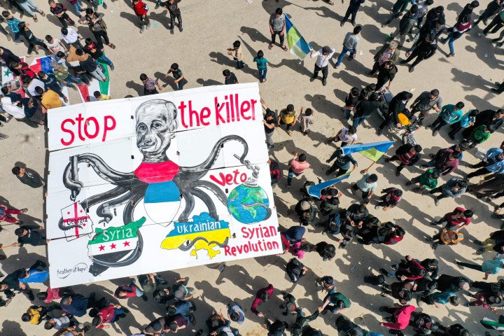 Protestors and a poster of Putin during demonstration in the city of Binnish in Syria's northwestern rebel-held Idlib province. (Source: Omar Haj Kadour via Getty Images) Protestors and a poster of Putin during demonstration in the city of Binnish in Syria's northwestern rebel-held Idlib province. (Source: Omar Haj Kadour via Getty Images)