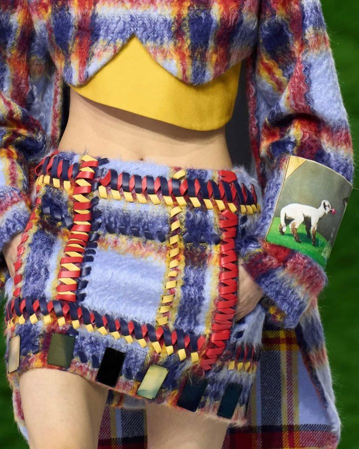 A model walks the runway showcasing a Louis Vuitton creation featuring a print of Nazar Strelyaiev-Nazarko's artwork Paramnesia (2023), where a lamb is depicted wearing luxury boots. (Source: Nazar Strelyaiev-Nazarko's/Instagram)