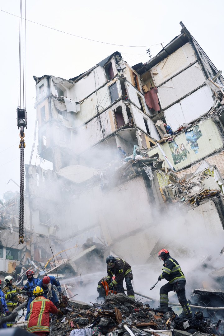 Emergency crews search through the ruins of a nine-story residential building hit by a Russian missile. Kyiv, Ukraine. July 31, 2025. Photo by Josh Olley/UNITED24 Media