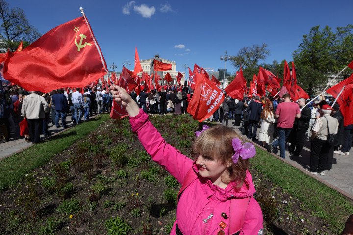 A Russian Communist Party supporter waves a Soviet flag during a rally of communists, while celebrating the International Worker's Day, May 1, 2024, in Moscow, Russia. Photo by Contributor/Getty Images.