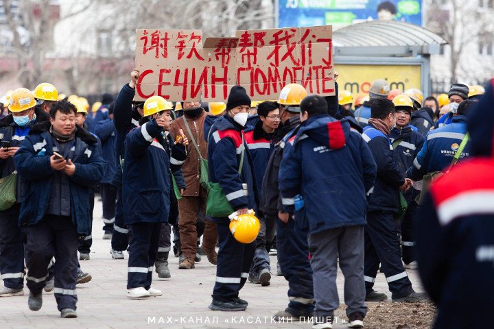 Protesters carry signs in Chinese and Russian calling for assistance from Rosneft CEO Igor Sechin. (Source: Kasatkin Writes)