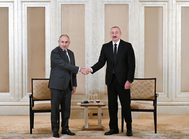 Azerbaijani President Ilham Aliyev (R) and Armenian Prime Minister Nikol Pashinyan (L) meet in Abu Dhabi, the capital of the United Arab Emirates on July 10, 2025. (Photo by Azerbaijani Presidency/Handout/Anadolu via Getty Images)