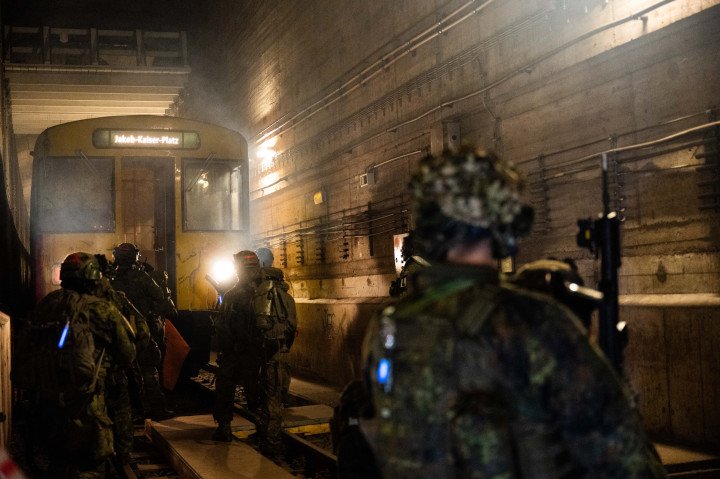 Bundeswehr soldiers run toward a subway train during Operation “Bollwerk Bärlin,” a nighttime drill simulating an attack in Berlin’s Jungfernheide tunnel. (Source: Getty Images)