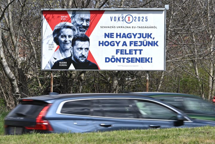 A Fidesz campaign poster depicting the President of the European People's Party (EPP) Manfred Weber, President of the European Commission Ursula von der Leyen and Ukrainian President Volodymyr Zelensky and reading 'Voting 2025: about Vote for Ukraine in the EU membership, Don't let them decide for us!' (Source: Attila Kisbenedek via Getty Images) A Fidesz campaign poster depicting the President of the European People's Party (EPP) Manfred Weber, President of the European Commission Ursula von der Leyen and Ukrainian President Volodymyr Zelensky and reading 'Voting 2025: about Vote for Ukraine in the EU membership, Don't let them decide for us!' (Source: Attila Kisbenedek via Getty Images)