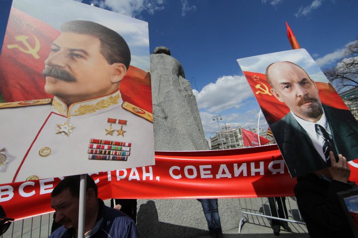 Russian Communist Party activists hold posters with portraits of Soviet leaders Vladimir Lenin and Joseph Stalin during the rally, hosted by their party, marking the Labour Day, May,1,2022, in Moscow, Russia. Photo by Konstantin Zavrazhin/Getty Images.