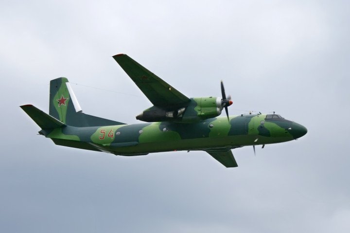 Russian Air Force An‑26 (54 red) flying lab in flight under cloudy skies. (Photo: Getty Images)