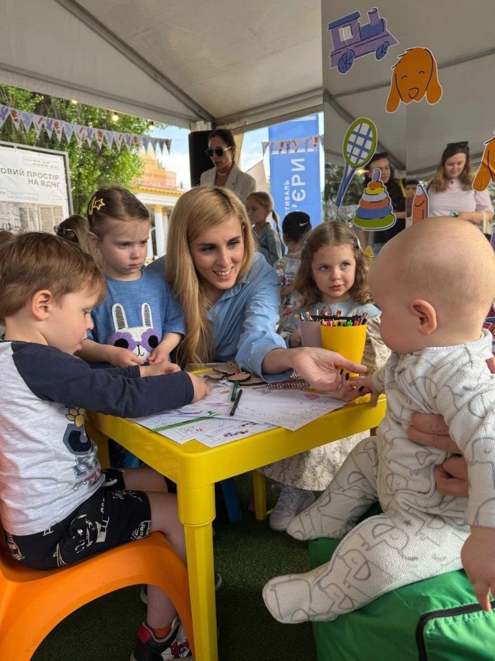 Iryna Tuliakova at the “Ukraine for Every Child” interactive space during the Book Country festival, where visitors could learn more about adoption, guardianship, foster care, and other ways to support children growing up without parental care. (Source: Personal archive of Iryna Tuliakova)