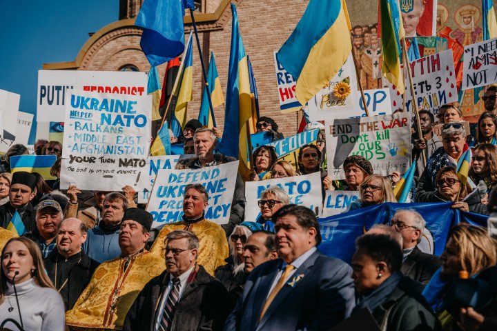 Lori Lightfoot, mayor of Chicago, lower right, and J. B. Pritzker, Illinois' governor, lower center, gather with demonstrators during a protest against the Russian invasion of Ukraine in front of Saints Volodymyr and Olha Ukrainian Church in Chicago, Illinois, U.S., on Sunday, Feb. 27, 2022. Photographer: Jamie Kelter Davis/Bloomberg via Getty Images Lori Lightfoot, mayor of Chicago, lower right, and J. B. Pritzker, Illinois' governor, lower center, gather with demonstrators during a protest against the Russian invasion of Ukraine in front of Saints Volodymyr and Olha Ukrainian Church in Chicago, Illinois, U.S., on Sunday, Feb. 27, 2022. Photographer: Jamie Kelter Davis/Bloomberg via Getty Images