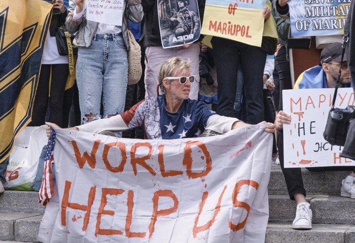 Routh holds a banner stating “World Help Us” during a demonstration in support of Mariupol defenders on May 3, 2022 in Kyiv, Ukraine. (Source: Getty Images) Routh holds a banner stating “World Help Us” during a demonstration in support of Mariupol defenders on May 3, 2022 in Kyiv, Ukraine. (Source: Getty Images)