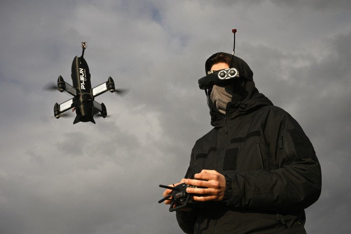 An employee of the Ukrainian SkyFall company conducts a test flight with a P1-Sun interceptor drone (Photo by Genya Savilov via Getty Images)