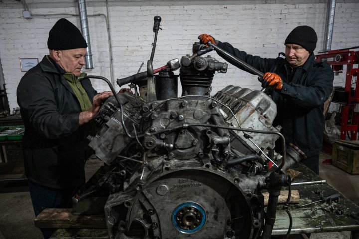 Ukrainian servicemen repair engines of military trucks at an undisclosed location in Ukraine, November 7, 2025. (Source: Getty Images)