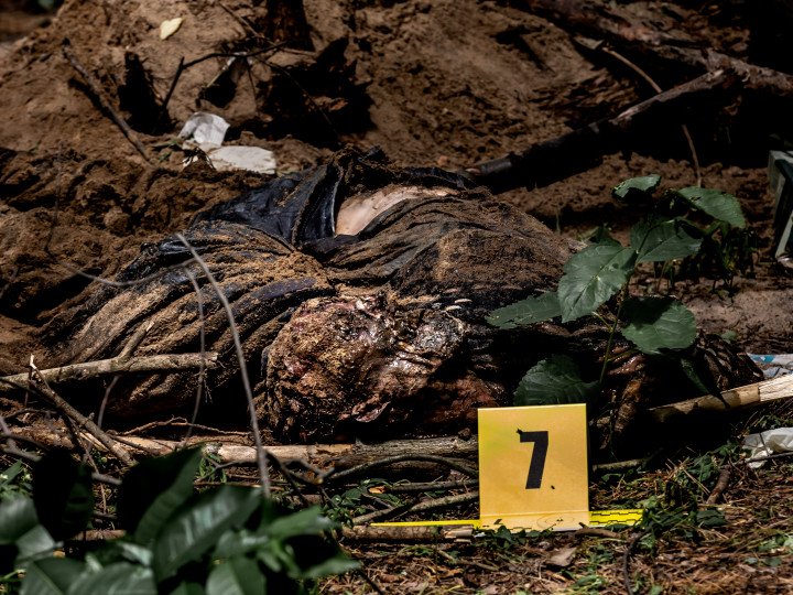 Ukrainians murdered by Russian army lie on a ground after being excavated in a forest near Bucha, Ukraine - June 13, 2022. (Source: Dominika Zarzycka via Getty Images)