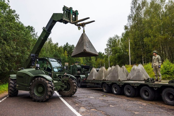 Lithuanian soldiers deploy “dragon’s teeth” anti-tank obstacles using military forklifts along a forested section of the border with Belarus. (Source: Lithuanian Armed Forces / Facebook)