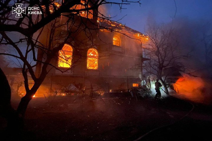 A firefighter works to extinguish a blaze in a residential building engulfed by flames following a Russian strike. The structure sustained heavy damage during the overnight attack. (Source: State Emergency Service of Ukraine)