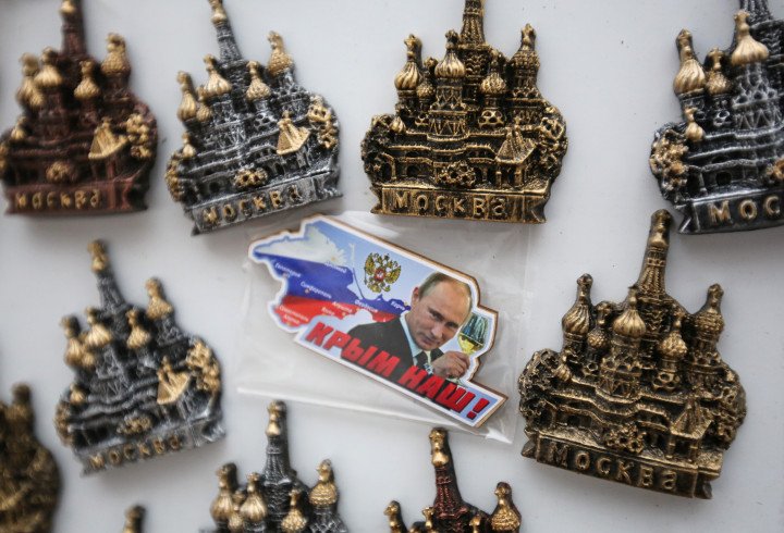 A fridge magnet reading "Crimea is ours" showing Vladimir Putin, Russia's leader, raising a glass, sits for sale beside magnets of St Basil's cathedral in Moscow, Russia, in Jan. 30, 2015. Photo: Andrey Rudakov/Bloomberg via Getty Images A fridge magnet reading "Crimea is ours" showing Vladimir Putin, Russia's leader, raising a glass, sits for sale beside magnets of St Basil's cathedral in Moscow, Russia, in Jan. 30, 2015. Photo: Andrey Rudakov/Bloomberg via Getty Images