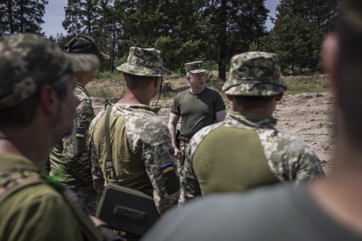 Ukrainian Commander-in-Chief ,Oleksandr Syrskyi, (center)  (the commander of the Ground Forces of the Armed Forces of Ukraine at the time) addresses troops before a military training exercise on June 21, 2023, at an unspecified location in Ukraine. (Photo by Ed Ram For The Guardian)