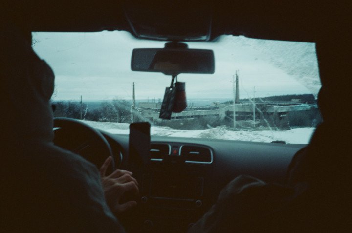 Driving with Jag, a destroyed factory visible in the distance. December 24, 2025. Izium region. Photo by Joshua Olley/UNITED24 Media. Driving with Jag, a destroyed factory visible in the distance. December 24, 2025. Izium region. Photo by Joshua Olley/UNITED24 Media.