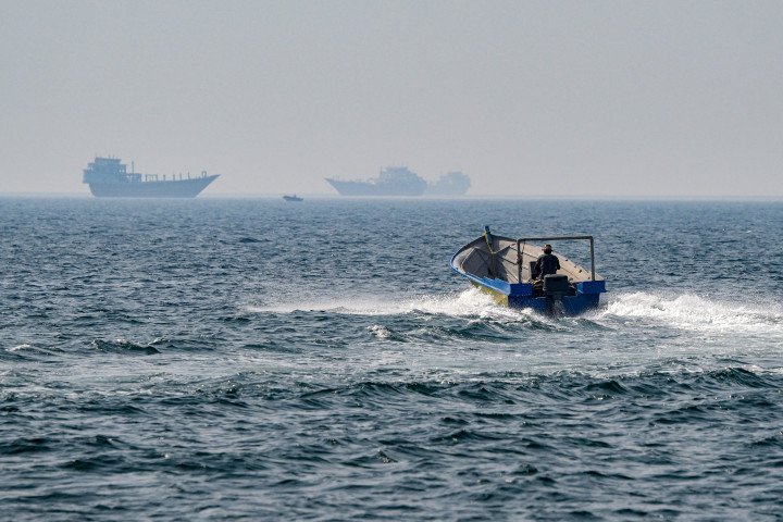 A boat sails in the waters of the Strait of Hormuz off Khasab in Oman's northern Musandam peninsula (Photo by Giuseppe CACACE via Getty Images)
