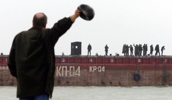 Ukrainian soldiers on a pontoon block Russian workers from extending a dam near Tuzla Island in the Azov Sea, October 24, 2003. On September 29, Krasnodar officials approved building a dike toward Tuzla in the Kerch Strait. Ukraine denounced the project as a land grab. (Photo: DENIS SINYAKOV/AFP via Getty Images)