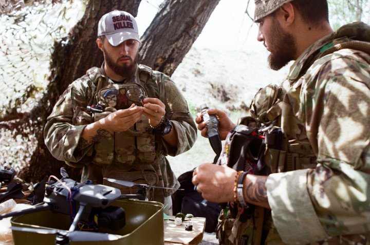 The twin brothers explain the difference in explosives they can attach to the Mavics. Ukraine, August 2025. Photo by Lucile Brizard/UNITED24 Media.