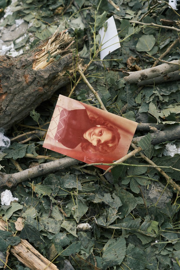 A family photo lies among broken branches and blown-out insulation—one of countless memories scattered by Russia’s overnight drone and missile attack. Kyiv, Ukraine. July 31, 2025. Photo by Josh Olley/UNITED24 Media