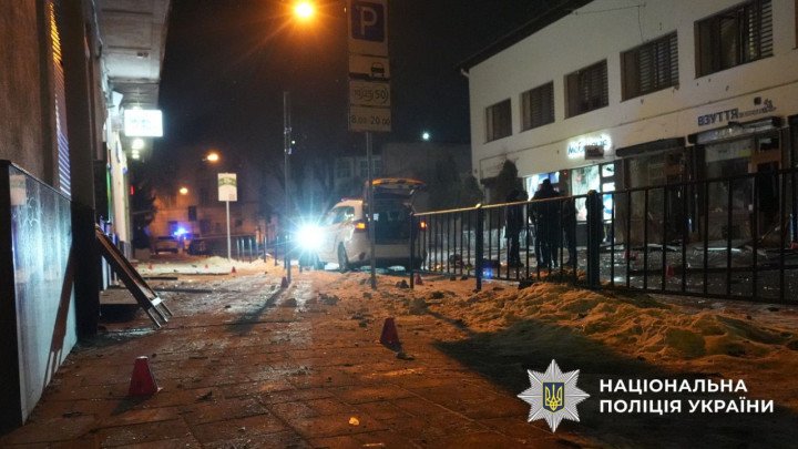 Emergency lights illuminate the street in central Lviv following the explosions, with forensic markers placed along the sidewalk. (Source: National Police of Ukraine)
