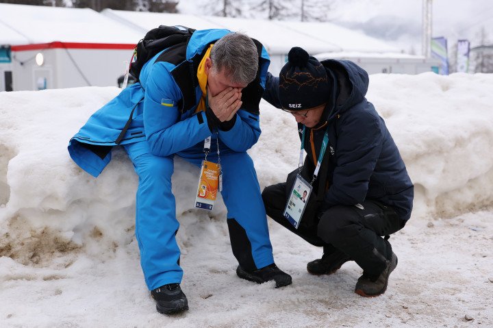 Chanmin Chyun, President of the Korea Bobsleigh and Skeleton Federation (R) consoles Mykhailo Heraskevych, father and coach of Vladyslav Heraskevych, after Heraskevych was disqualified. Photo by Richard Heathcote/Getty Images. Chanmin Chyun, President of the Korea Bobsleigh and Skeleton Federation (R) consoles Mykhailo Heraskevych, father and coach of Vladyslav Heraskevych, after Heraskevych was disqualified. Photo by Richard Heathcote/Getty Images.
