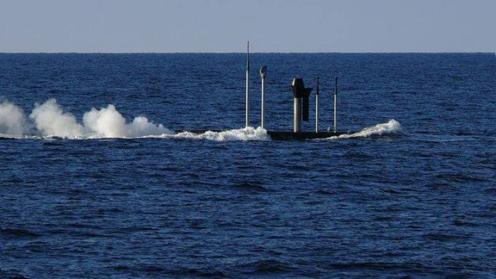 Extendable masts of a Project 877EKM “Paltus” submarine in semi-submerged position, including periscope and antenna systems. (Source:  Defense Express)