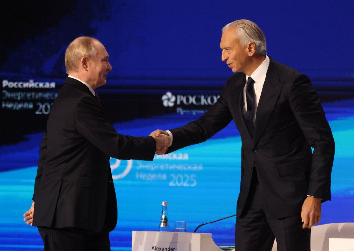 Russian President Vladimir Putin (L) shakes hands with Gazprom Neft CEO Alexander Dyukov (R), October 16, 2025. (Photo by Contributor/Getty Images)