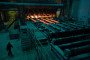 A worker passes lengths of red hot steel emerging from a shaping machine in the rolling shop at the Oskol Elektrometallurgical Plant (OEMK) steel mill, operated by Metalloinvest Holding Co., in Stary Oskol, Russia. (Source: Getty Images)