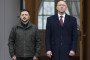 Poland's President Karol Nawrocki and Ukraine's President Volodymyr Zelenskyy attend a welcome ceremony prior to talks at the Presidential Palace in Warsaw, Poland, on December 19, 2025. (Source: Getty Images)