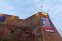 A poster set up on the Russia-facing wall of the Hermann Castle in Narva on May 9, 2025. (Source: Sergei Mihhailov/ERR)