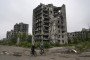 People ride bicycles on a road in front of the heavily damaged buildings in Mariupol, one of the cities with the most intense conflicts, as Russia-Ukraine war continues in Mariupol, Ukraine on September 29, 2022. (Source: Getty Images)