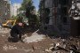 Ukrainian President Volodymyr Zelenskyy pays tribute to the victims at the site of a nine-story residential building partially destroyed by a Russian missile strike in Kyiv, Ukraine on May 15, 2026. (Source: Getty Images)