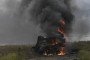 A destroyed Russian MT-LB armored vehicle burns in a field near Izium, Kharkiv region. (Source: Getty Images)