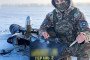 A Ukrainian soldier poses with debris from a downed Russian Geran-2 (Shahed) drone, intercepted by a Sting drone in a snowy field. (Photo: Wild Hornets)