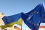 Protesters hold Ukrainian and EU flags during a demonstration under the slogan “Don’t Be Indifferent” at Szczepanski Square in Krakow, Poland, on August 9, 2026. (Source: Getty Images)