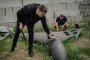 Dmytro Chubenko (R), spokesperson of the Kharkiv prosecutor, and his assistant look at a Russian Shahed drone shot down by Ukraine’s air defense forces. (Source: Getty Images)