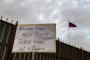 A sign is lifted as Ukrainians and Cypriots take part in a protest against Russia’s invasion of Ukraine, outside the Russian embassy in the Cypriot capital Nicosia on March 1, 2022. (Source: Getty Images)